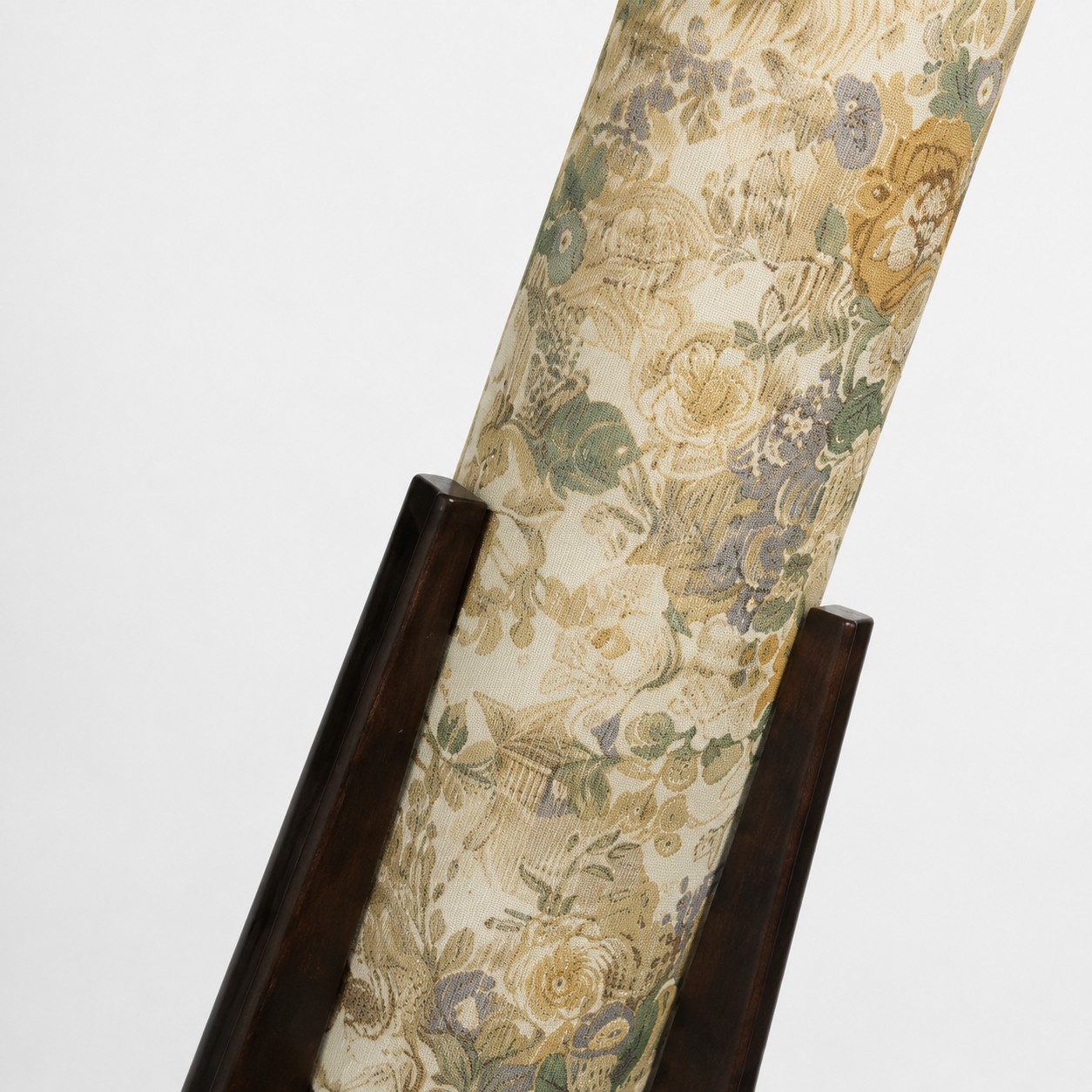 Close-up of Liberty fabric shade supported by dark solid wood tripod legs